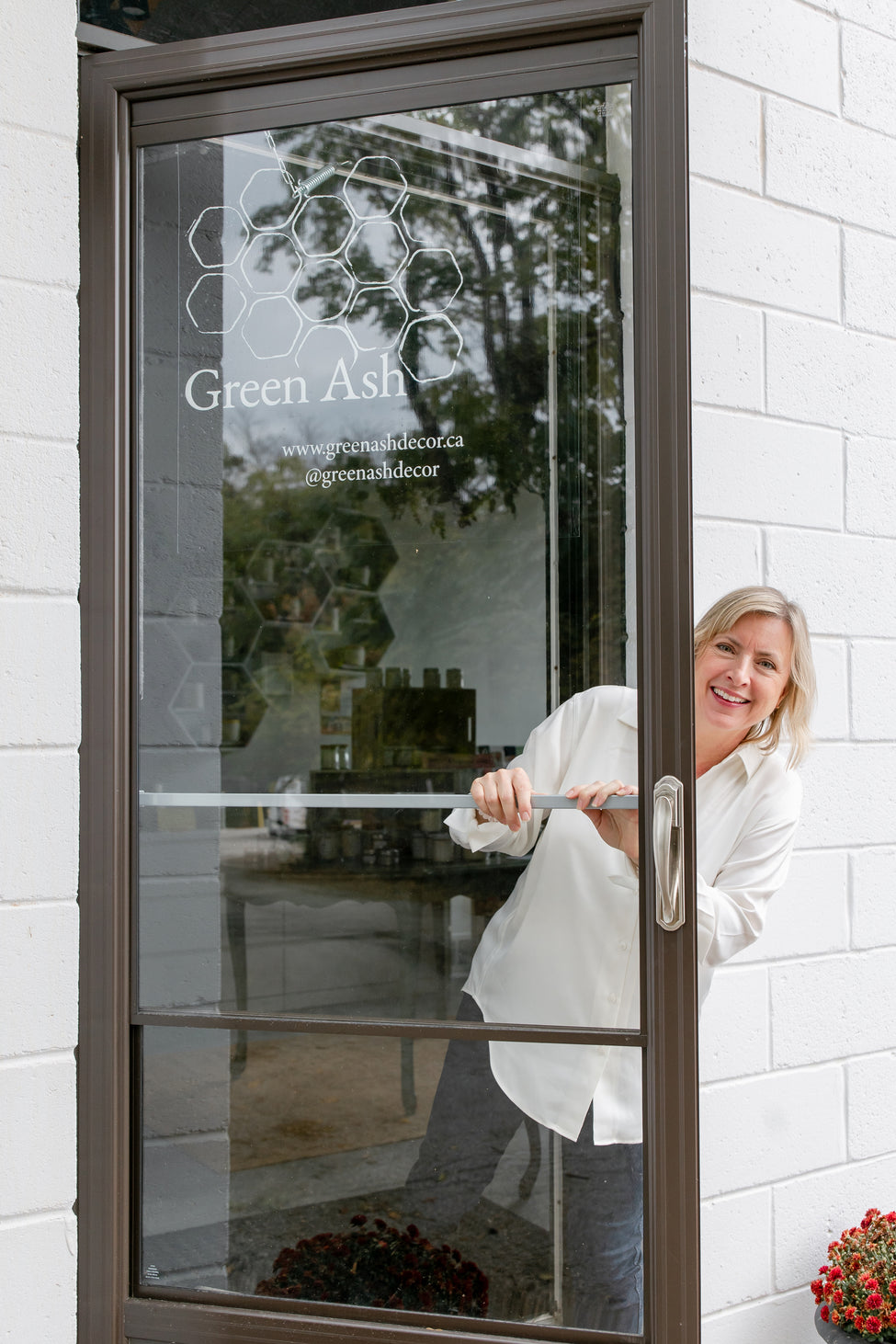 Green Ash's Owner, Lisa, outside her store front, smiling