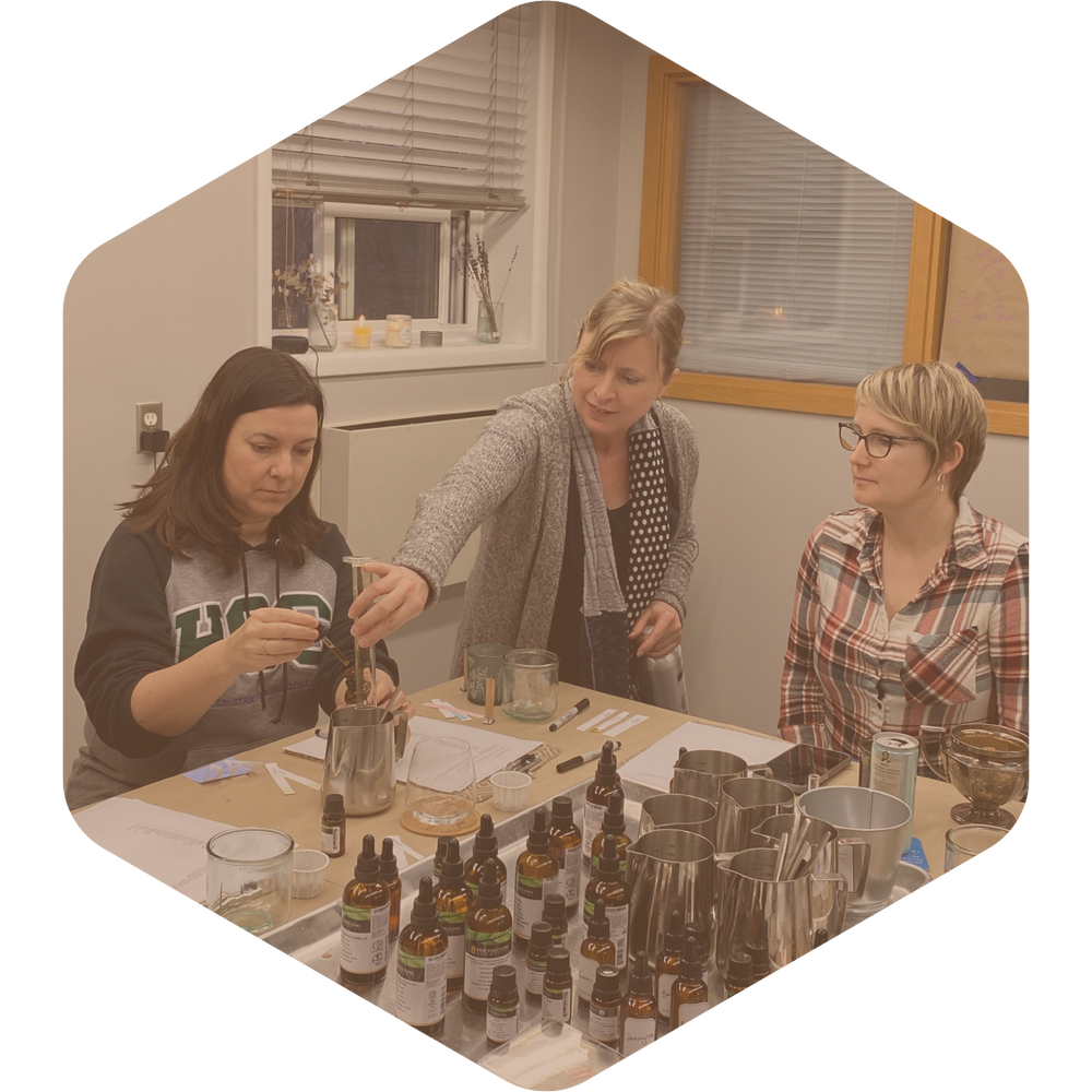 Green Ash Workshop Image. Lisa with two of her customers, going through her candle making workshop.